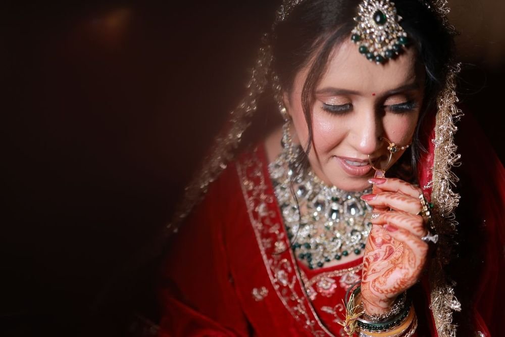 Smiling bride in red with bridal jewellery