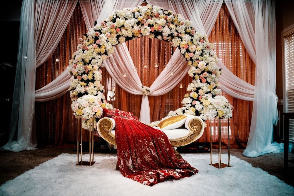 Flower arch and draped stage set for a celebration
