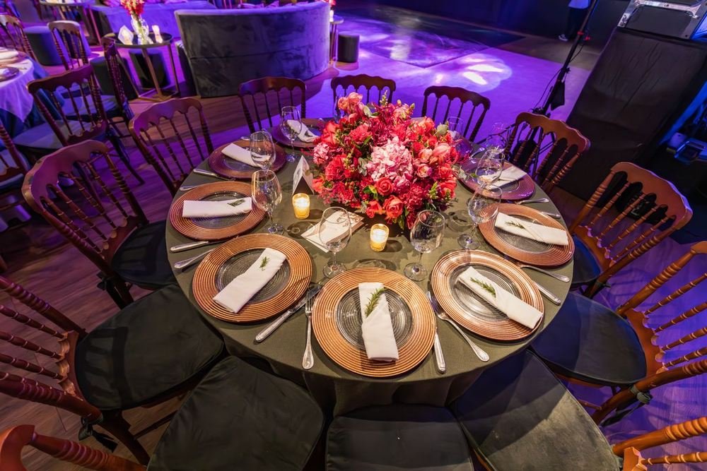 Round dinner table set with flowers at a corporate gala