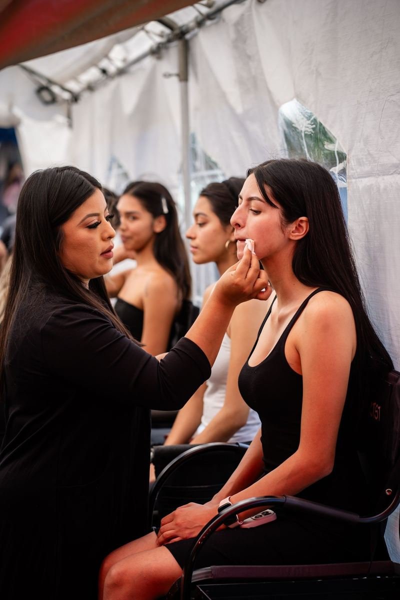 Make-up artist preparing a model backstage