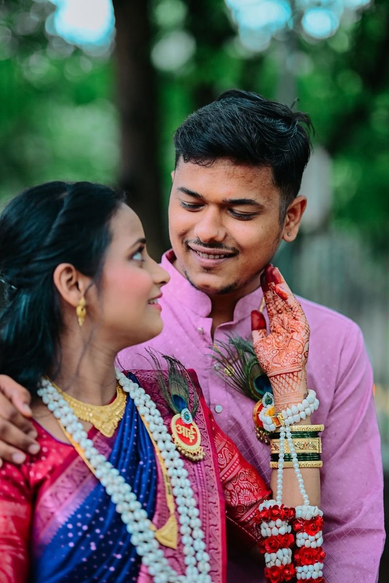 Couple smiling with flower garlands