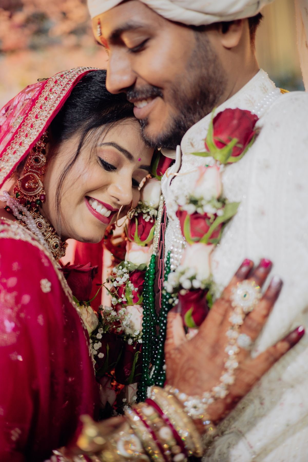 Bride and groom smiling cheek to cheek in wedding clothes