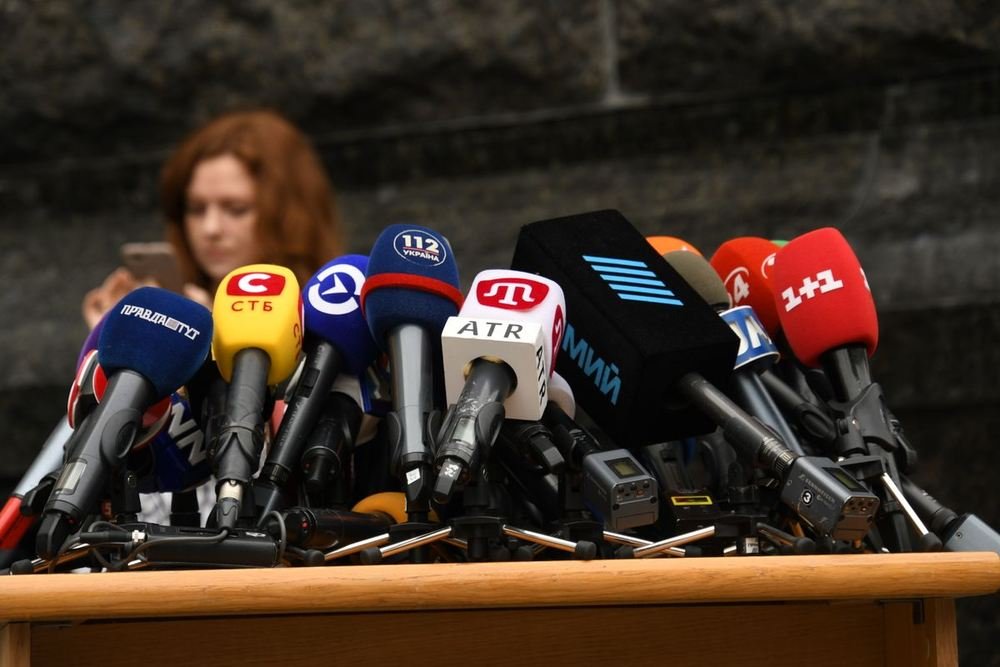 Speaker at a press conference in front of microphones