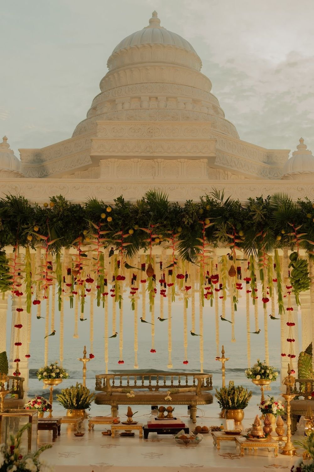 Flower mandap in front of a domed palace