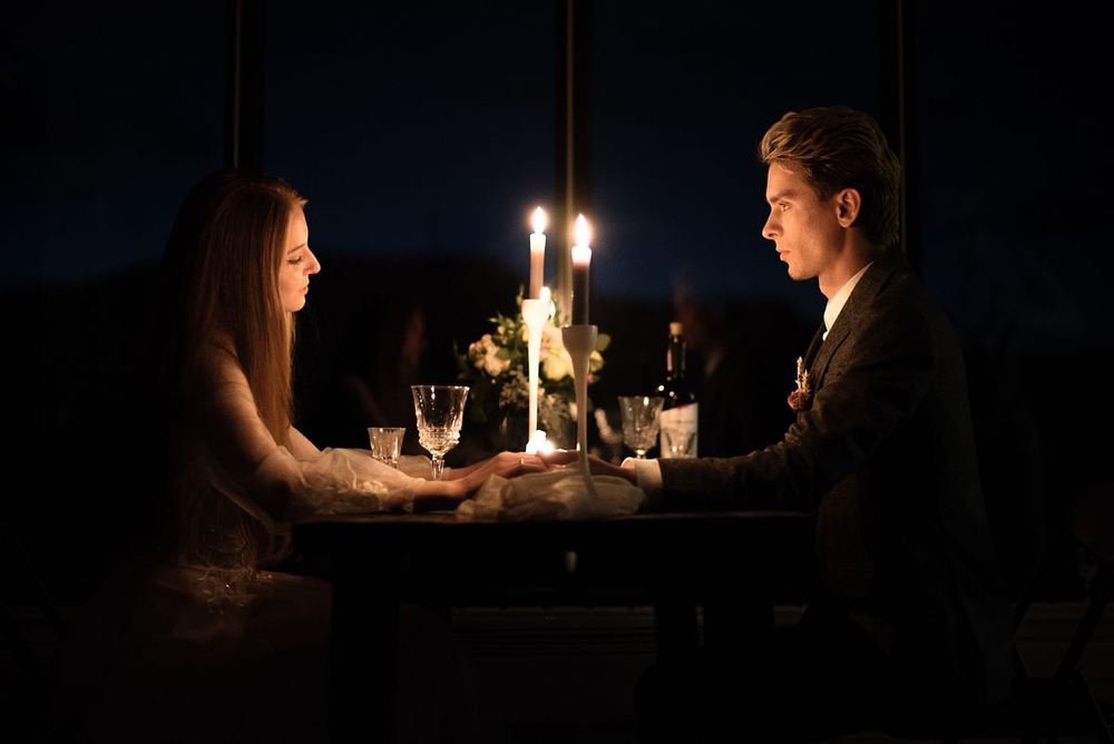 Couple at a candlelit anniversary dinner