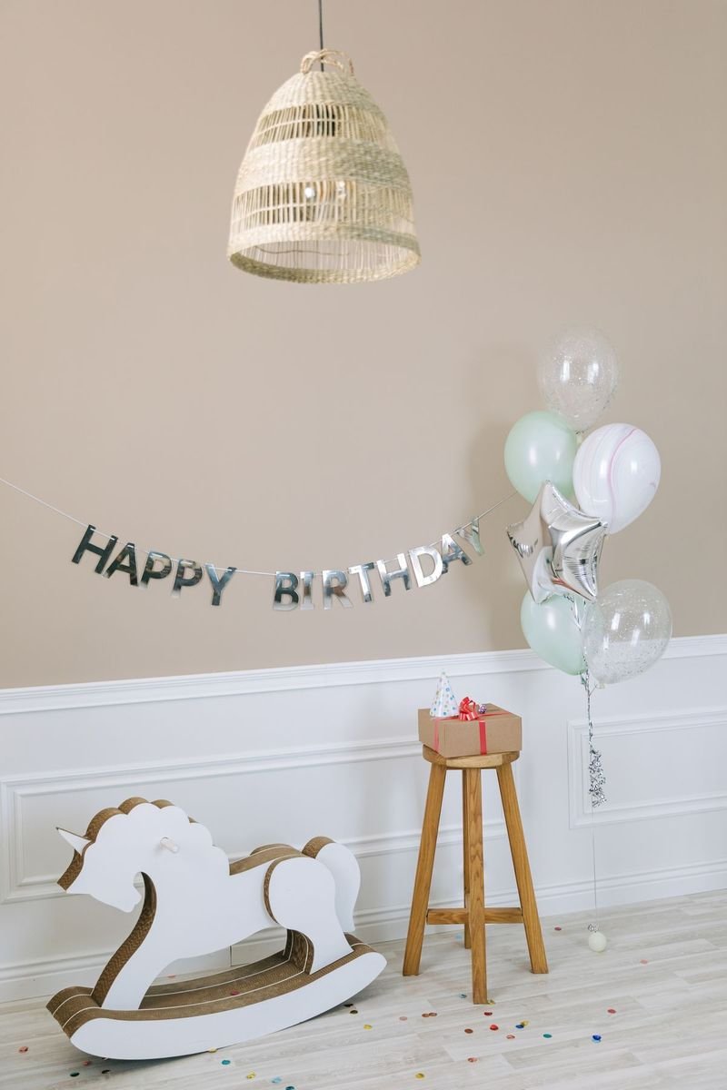 Birthday décor with balloons and a wooden rocking horse